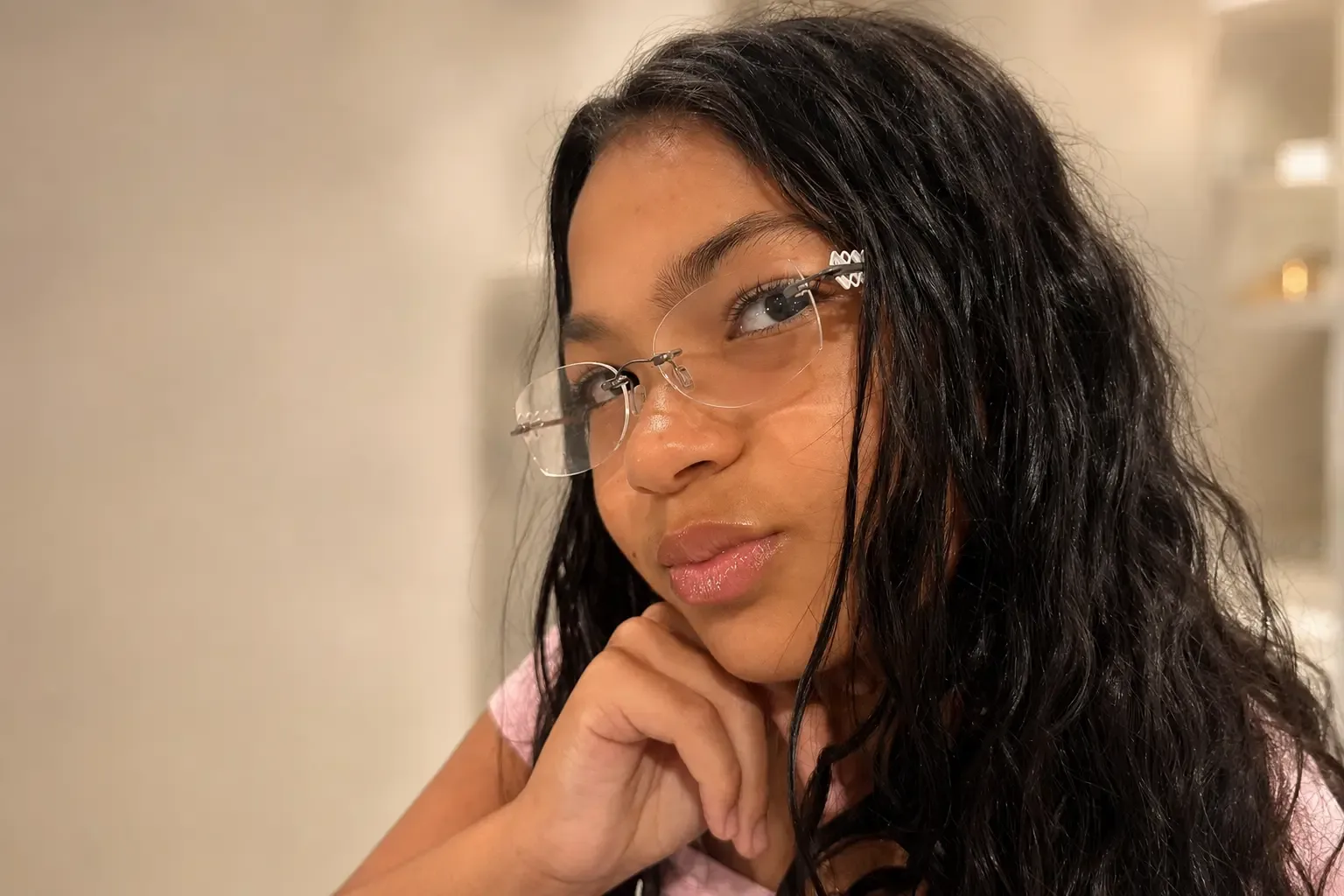 Teen wearing rimless eyeglasses at Modern Spectacle